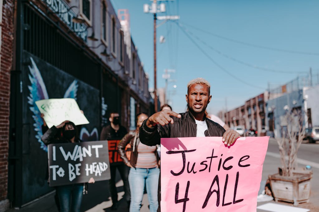 A group of activists holding signs demanding justice during a peaceful protest in the city.