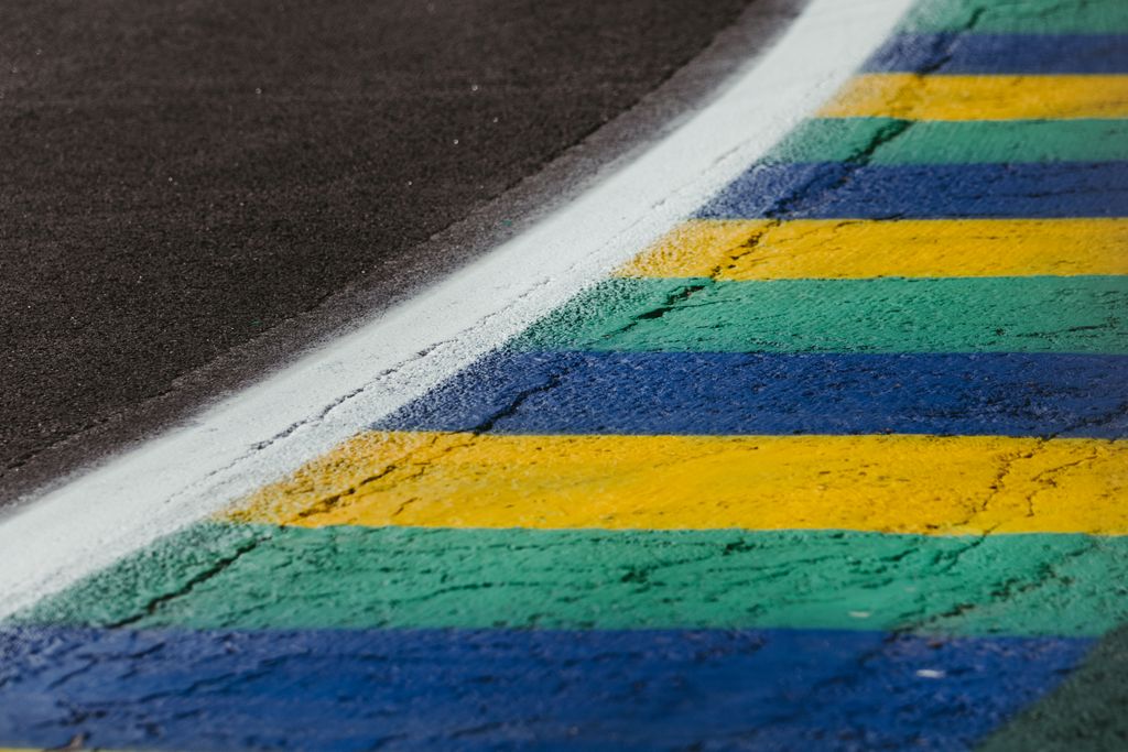 A close-up view of a colorful racetrack curb at the Interlagos Circuit in São Paulo, Brazil.